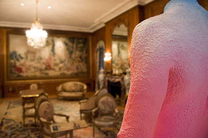 Alex Israel’s Self-Portrait (Wetsuit) stands directly across from The Fountain of Love, one of the 18th-century French tapestries in the Large Library of the Huntington Art Gallery. Photo by Kate Lain.