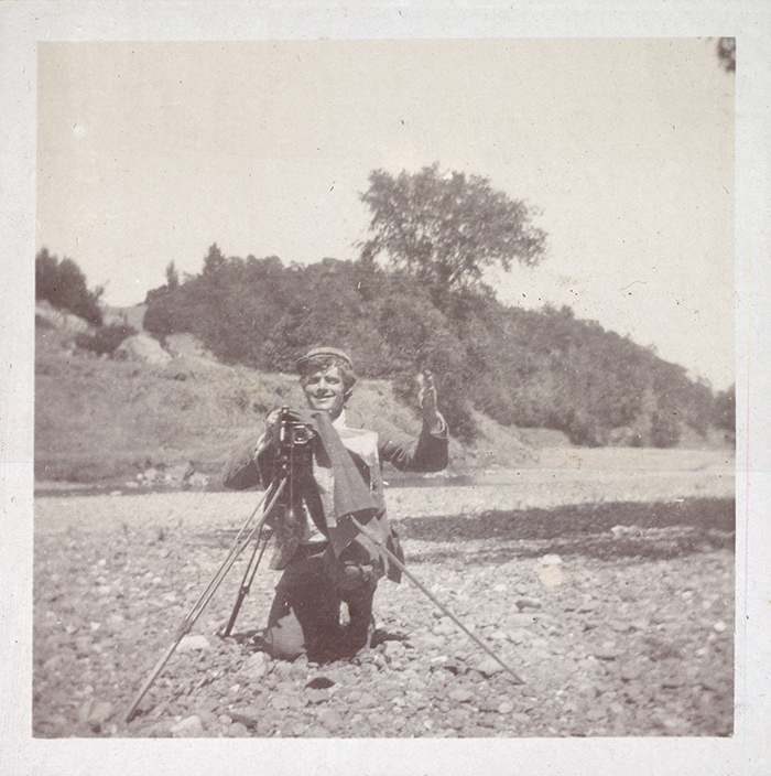 Jack London kneels by his camera, ca. 1900. Jack London Collection. The Huntington Library, Art Collections, and Botanical Gardens.