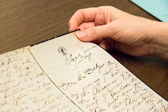 Shirley Samuels holds the letter that Menken wrote to theater entrepreneur Augustin Daly from her home, which she called “Bleak House,” a reference to the 1853 novel by Charles Dickens. Menken dedicated her book of poems, Infelicia, to Dickens. Photo by Kate Lain. The Huntington Library, Art Collections, and Botanical Gardens.