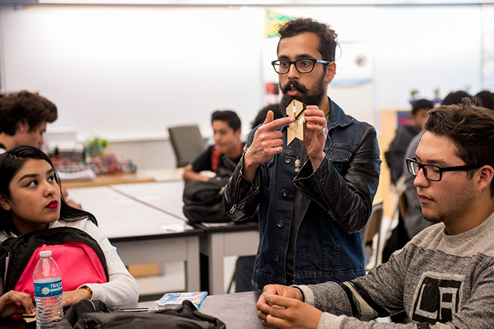 Manan Arya, a Caltech graduate student, designs and tests methods for packaging and deploying large, thin structures for spacecraft. Arya taught engineering students at Esteban E. Torres High School some of the origami folding techniques that inspire his work. Photo by Martha Benedict.