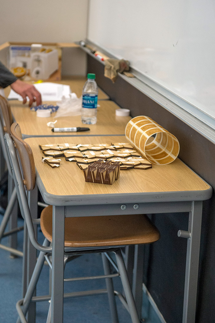 Origami techniques can be used with wood or with composite materials, like this cylinder made from glass fibers, mixed with a stiff resin epoxy in the yellow areas and a soft silicone in the white regions. Photo by Martha Benedict.