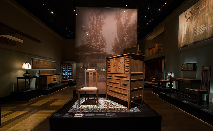 The newly installed permanent exhibition of Greene & Greene architecture and design in the Dorothy Collis Brown Wing. A black walnut and ebony chiffonier and matching chair from the master bedroom of the 1908 Gamble House take center stage.