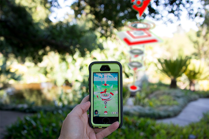 People are using their smartphones to play the popular augmented-reality game Pokémon GO at The Huntington. Pictured is a Pokémon gym located at the Lily Ponds. Image by Kate Lain.
