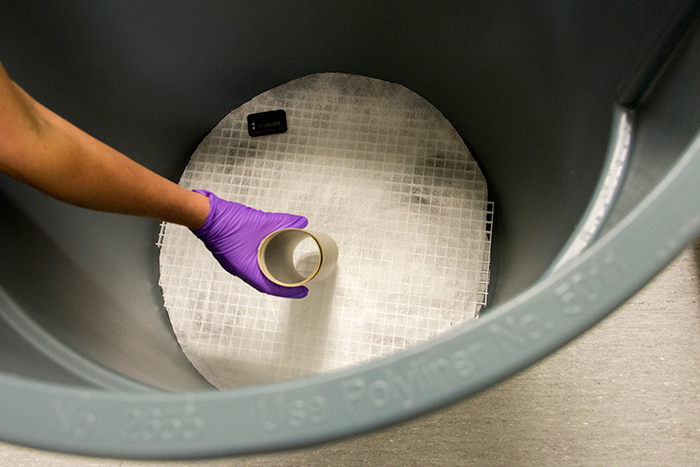 First step: Humidify the rolled panoramic photos in a modified trash bin. Photo by Kate Lain.