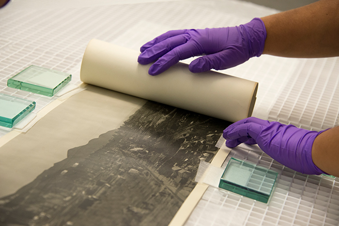 After several more hours in a large, flat humidification sink, the photos can start to be unrolled. Photo by Kate Lain.