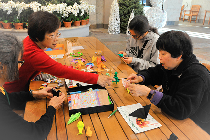 Visitors to the exhibition will find a table outside the gallery for impromptu origami folding. Photo by Andrew Mitchell.