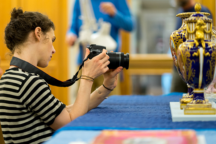 Juliana Wisdom photographs Sèvres porcelain at The Huntington as part of her research. Photo by Aric Allen.