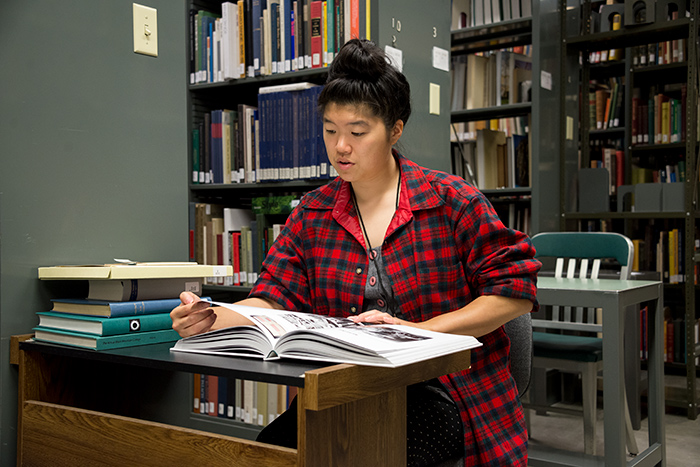 Soyoung Shin reads about textiles in the Huntington Library. Photo by Kate Lain.