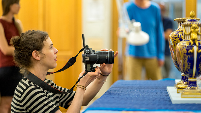 Juliana Wisdom photographs Sèvres porcelain at The Huntington as part of her research. Photo by Aric Allen.