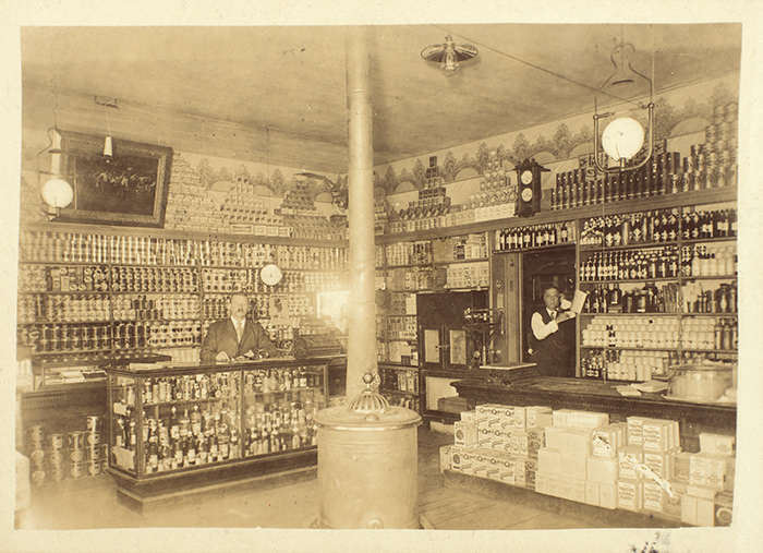 This photograph likely depicts J. H. F. Ahlert and C. L. Forsha in their Ahlert & Forsha grocery store in Dawson City in 1910. Unidentified photographer. The Huntington Library, Art Collections, and Botanical Gardens.
