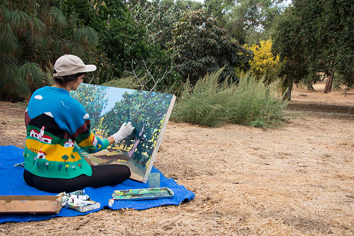 Artist Sarita Dougherty paints in an uncultivated part of The Huntington’s grounds. Photo by Kate Lain.