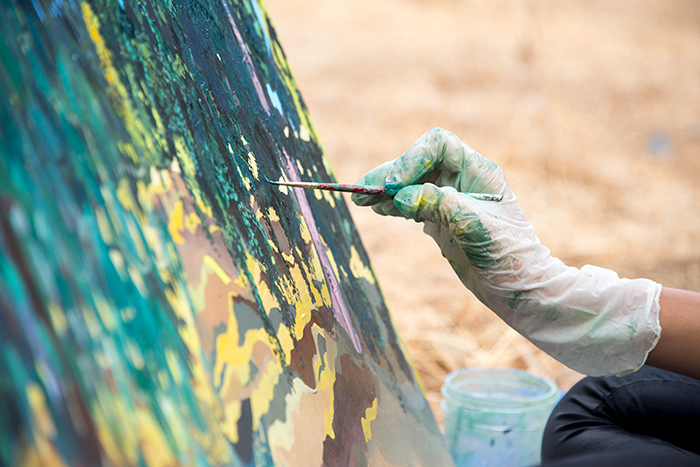 “Just being back here painting is the best thing,” says artist Sarita Dougherty, as she works in quiet in a lightly trodden area of The Huntington’s grounds. Photo by Kate Lain.