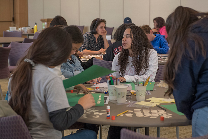 Students crafting their “found poem” in English and Spanish from words that appear in the “Visual Voyages” catalog and exhibition labels. Photo by Martha Benedict.