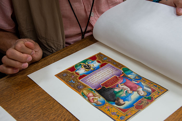 Mario Ybarra Jr. looks at an illustration detail from a collection of 15th- and 16th-century Italian illuminated manuscripts. The Huntington Library, Art Collections, and Botanical Gardens. Photo by Kate Lain.