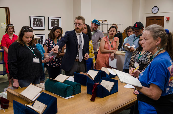 Joel Klein, the Molina Curator for the History of Medicine and Allied Sciences, discusses volumes from the 16th to the 18th century, including The secretes of reuerende Maister Alexis of Piemount… (1558) and Natural magick (1658) while Cynthia Lake (far right), a teacher from John Muir High School, and fellow teachers take note. Photo by Lisa Blackburn.