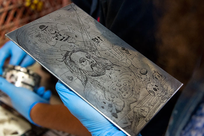 Ybarra holds a printing plate etched with his self-portrait. It was inspired by small, intimate works by Albrecht Dürer (1471–1528) and a portrait of Dürer himself by Wenceslaus Hollar (1607–1677) that Ybarra viewed at The Huntington. Photo by Kate Lain.