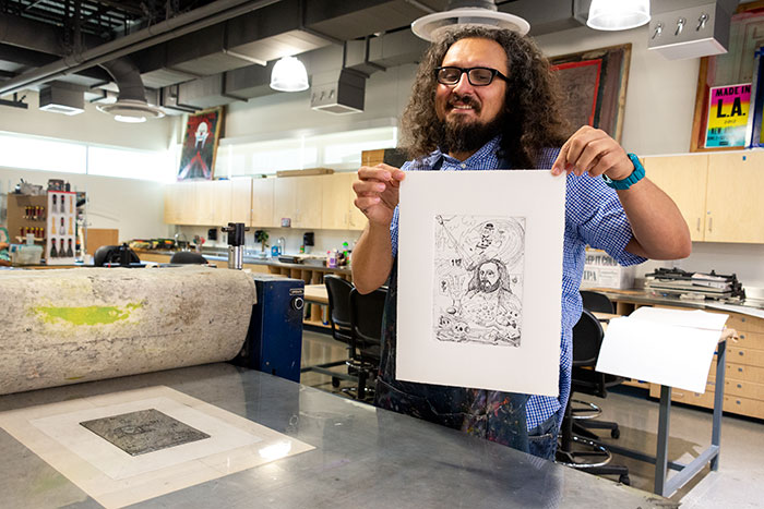 Ybarra holds a print of his self-portrait. Photo by Kate Lain.