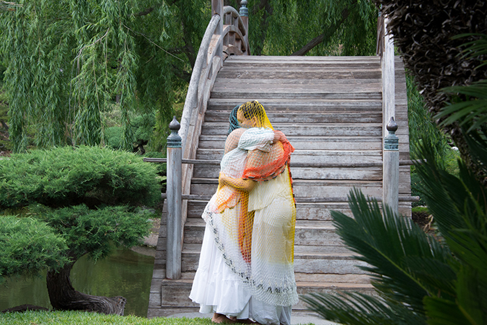 Dancers embrace in front of the Moon Bridge in The Huntington’s Japanese Garden. Photo by Deborah Miller.