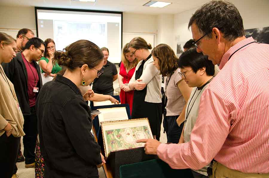 Daniel Lewis, Dibner Senior Curator of the History of Science and Technology at The Huntington, discusses the colorful, mid-16th-century Vallard Atlas with summer institute participants. Photo by Lisa Blackburn.