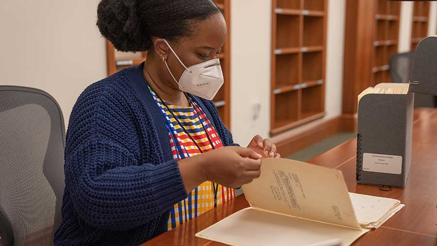 Alyssa Collins looking at Octavia E. Butler materials in The Huntington’s Ahmanson Reading Room. Photo by Aric Allen.