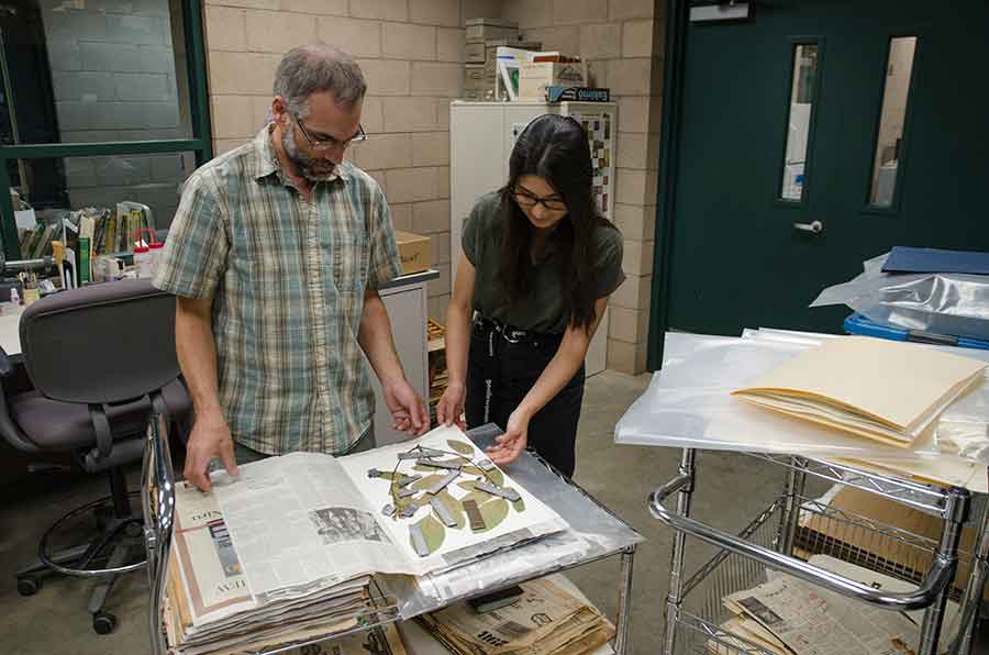 Brian Dorsey, The Huntington’s chief botanical researcher, and botanical intern Dana Austria examine plant materials that are being dried and collected for the Global Genome Initiative. Photo by Lisa Blackburn. 