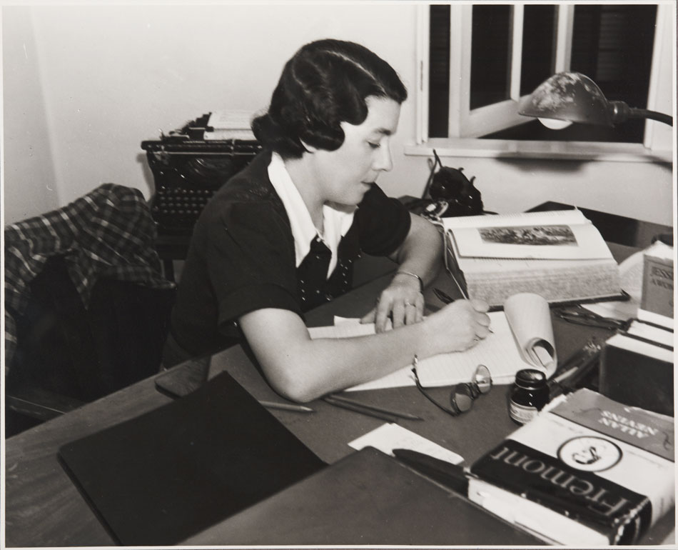 Photograph of Sonya Levien working at her desk, ca. 1933. The Huntington Library, Art Museum, and Botanical Gardens.