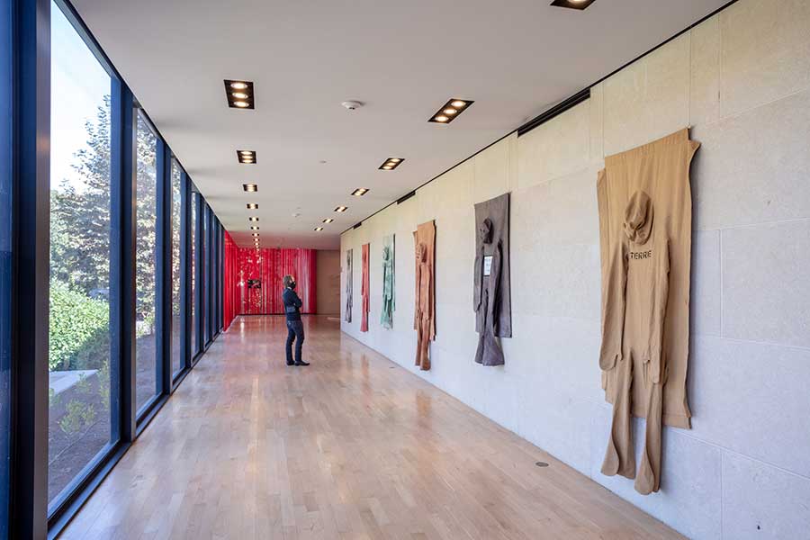 Nicola L.’s Pénétrables are on view in the Rothenberg Loggia of The Huntington’s Virginia Steele Scott Galleries of American Art. Nicola L., [left to right] Pénétrable (Cloud), Pénétrable (Flower), Pénétrable (Forest), Pénétrable (Forest), Pénétrable (We Don’t Want War), Pénétrable (Terre), 1970–78, dyed canvas, marker, wood. Nicola L. Estate. Photo by Joshua White.