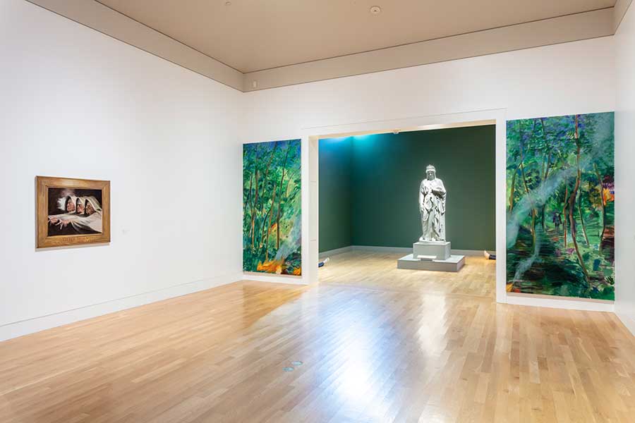 Patrick Jackson’s Heads, Hands, and Feet features human-modeled figures, like the ones whose feet are visible here, that lie supine on the floor near Harriet Goodhue Hosmer’s monumental sculpture, Zenobia in Chains. Jill Mulleady’s Interior of a Forest (diptych) frames Zenobia with a burning trail in a wooded scene. On the wall to the left is The Three Witches, Mulleady’s replica of Henry Fuseli’s painting of the same title in the Huntington Art Gallery; in her version, Mulleady has replaced the face of Fuseli’s leftmost witch with a self-portrait. Patrick Jackson, Head, Hands and Feet, 2011, resin, silicone, human hair, yak hair, denim clothing, 72 × 28 × 9 in. (182.9 × 71.1 × 22.9 cm). Courtesy of the artist and François Ghebaly, Los Angeles. Jill Mulleady, Interior of a Forest (diptych), 2020, oil on linen, 112 × 51 3/16 in. (284.5 × 130 cm). Courtesy of the artist. Jill Mulleady, The Three Witches, 2020, oil on linen, 36 1/4 × 40 15/16 in. (92 × 104 cm). Courtesy of the artist. Photo by Joshua White.