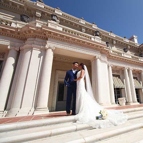 Wedding couple on the steps of Huntington Art Gallery